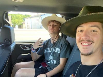In this selfie taken in a car, both Hunter Fieri and Ryder Fieri can be seen wearing a cowboy hat.